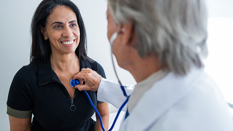 A doctor listens to a patient's heart